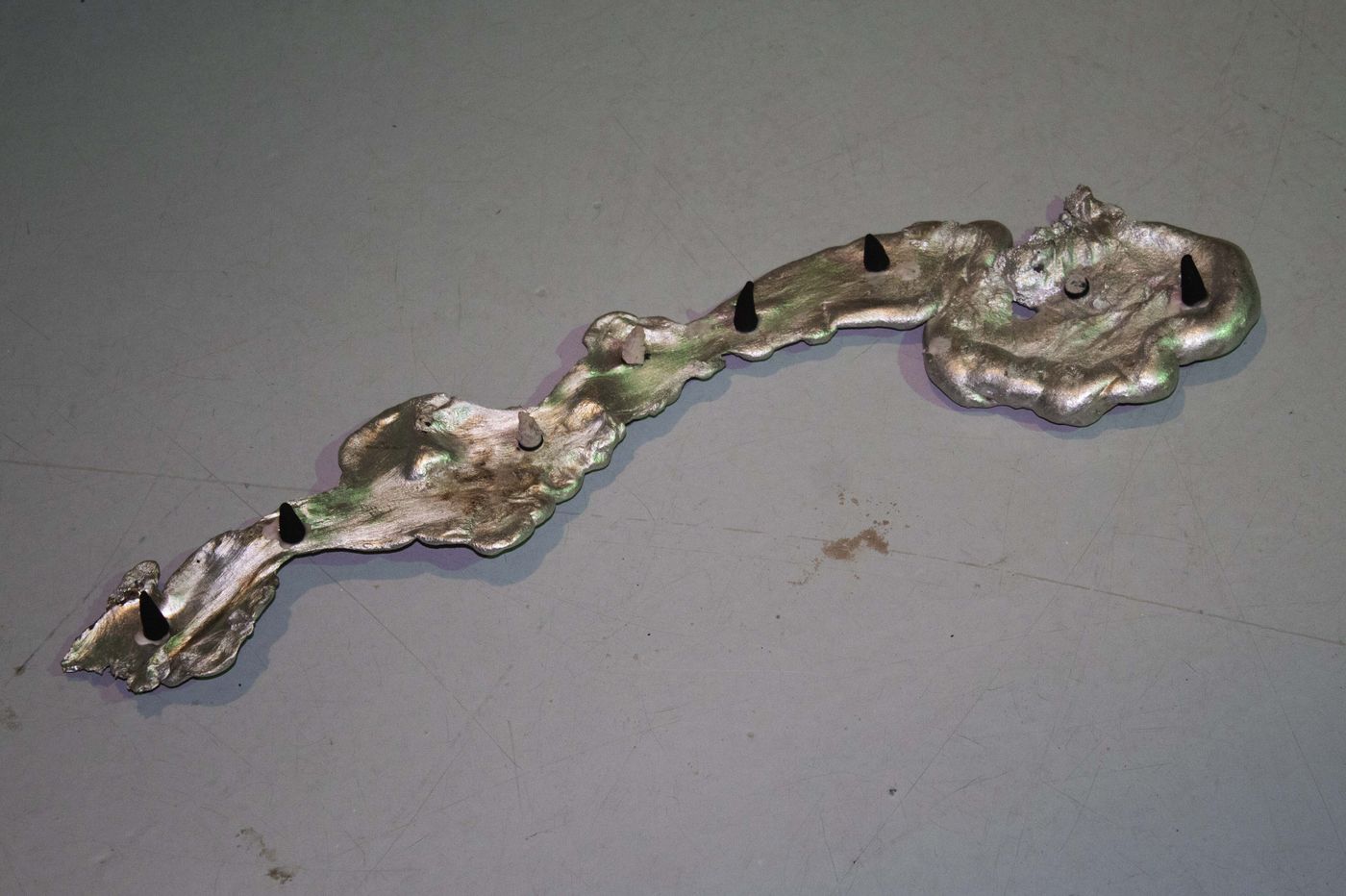 Cosmic alloy, teardrop of the earth, 2021. Aluminum and incense; 30 x 7 in.